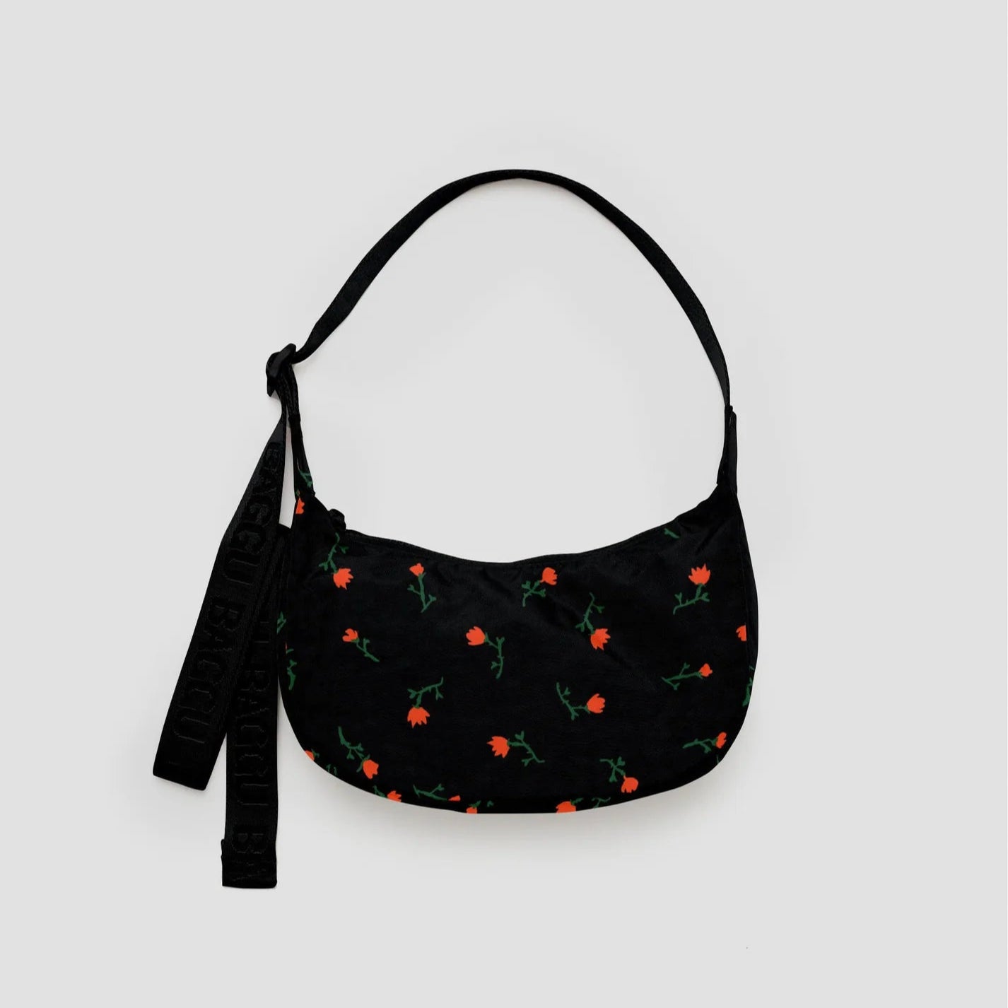 Black handbag with floral pattern on a light gray background