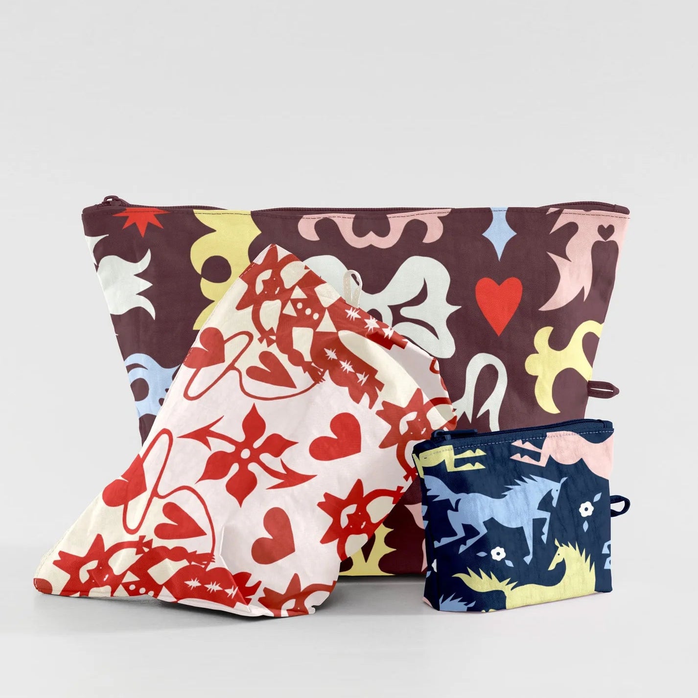 Three patterned pouches on a light gray background