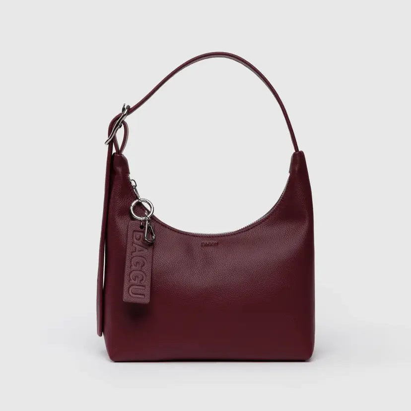 Maroon handbag with a visible brand logo on a light gray background