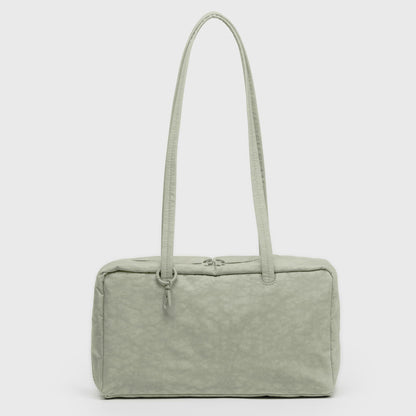 Light green handbag with a textured surface on a white background