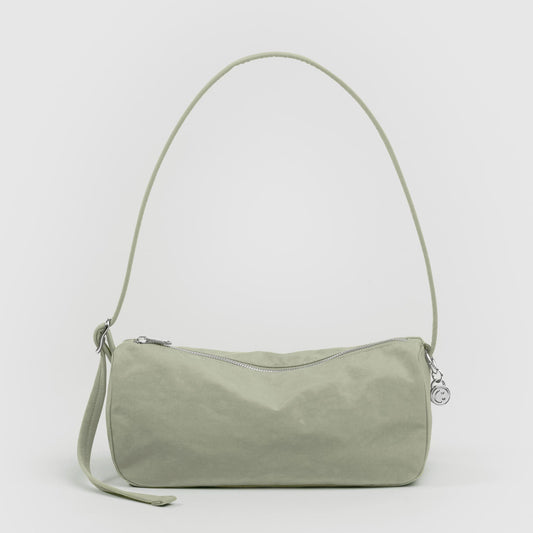 Green handbag with a strap on a white background
