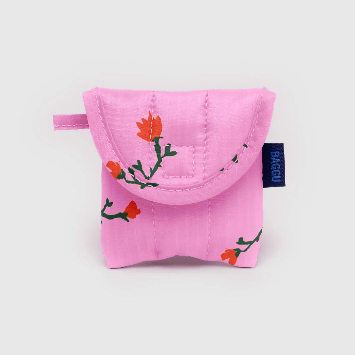 Pink earbud pouch with floral design on a light gray background