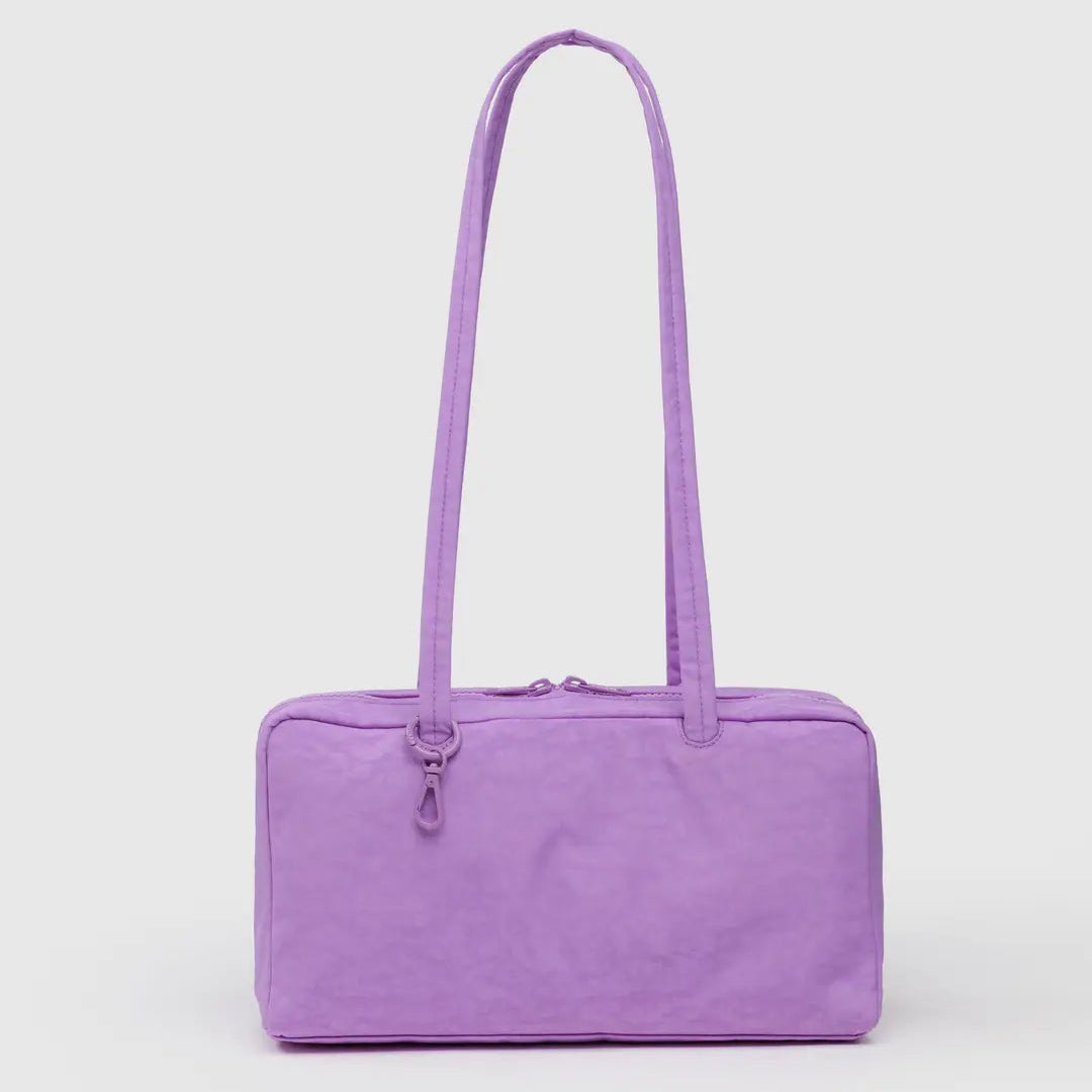 Purple handbag with a strap on a light grey background