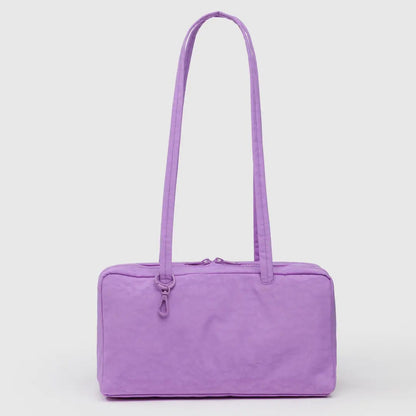 Purple handbag with a strap on a light grey background