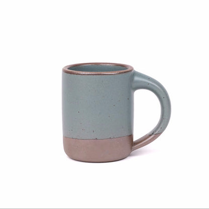 Blue ceramic mug with a brown base on a white background
